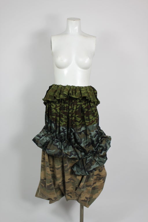 Cotton camouflage tiered skirt style harem pants in contrasting patterns. Peplum at waist with pouf at center.