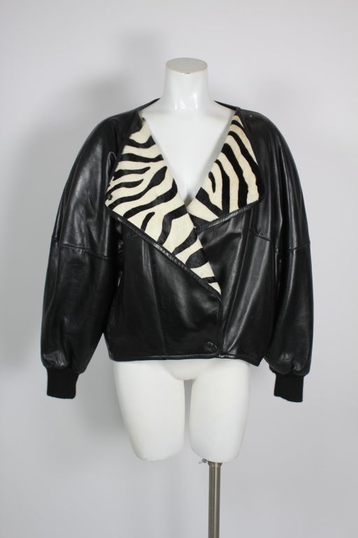 Black leather puff kacket with faux zebra print pony hair over-sized collar.  Snap closure.