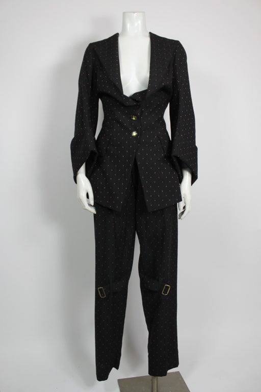 Wonderful Westwood ensemble -  a stylized, fitted frock coat. Oversized, folded cuffs, flared back. Low-cut. Includes matching bondage pants with zippers and buckles in a bright pinstripe of blue and red. Quintessentially Westwood.  Pant waist - 32