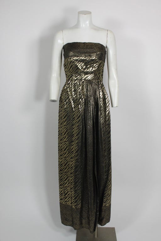 Luxurious gold lame animal print strapless gown from Pauline Trigere. Has a liquid-like quality and movement. Comes with scarf in same material.