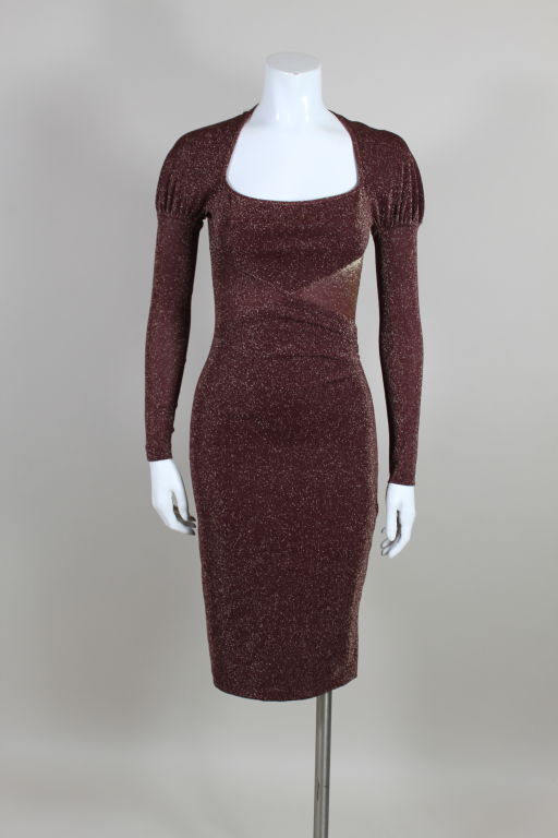 Ultra sexy, body-hugging dress from Vivienne Westwood is done in a stretchy wine red and gold lurex. Bodice has an illusion wrap silhouette, modified raglan sleeves and the iconic Westwood portrait collar. Measurements stretch up to 4