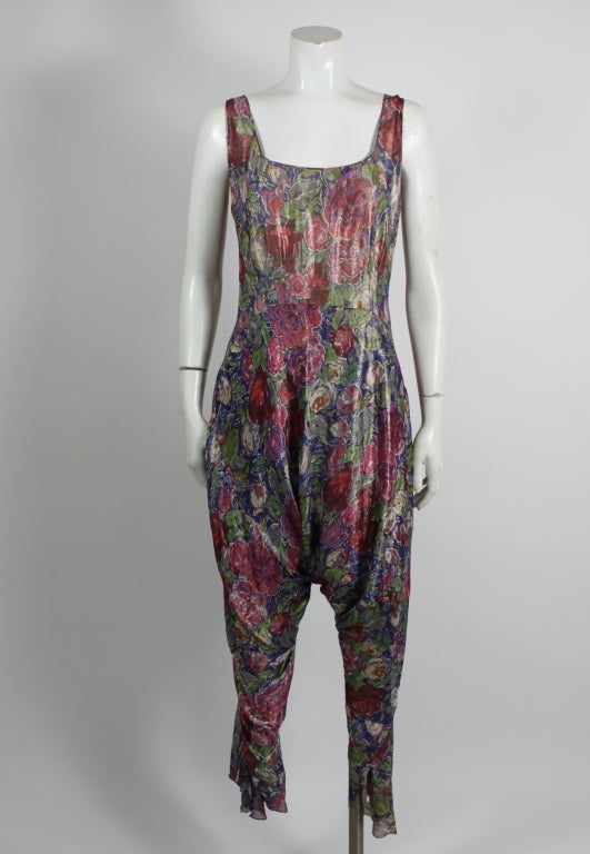 A rare example of the beauty of 1930s floral lamé, this jumpsuit is unusual, whimsical, and gorgeous. Fully lined and buttons on left side.  From the eccentric Mme. Najla Mogabgab, whose store on Fifth Avenue in New York carried a vast array of