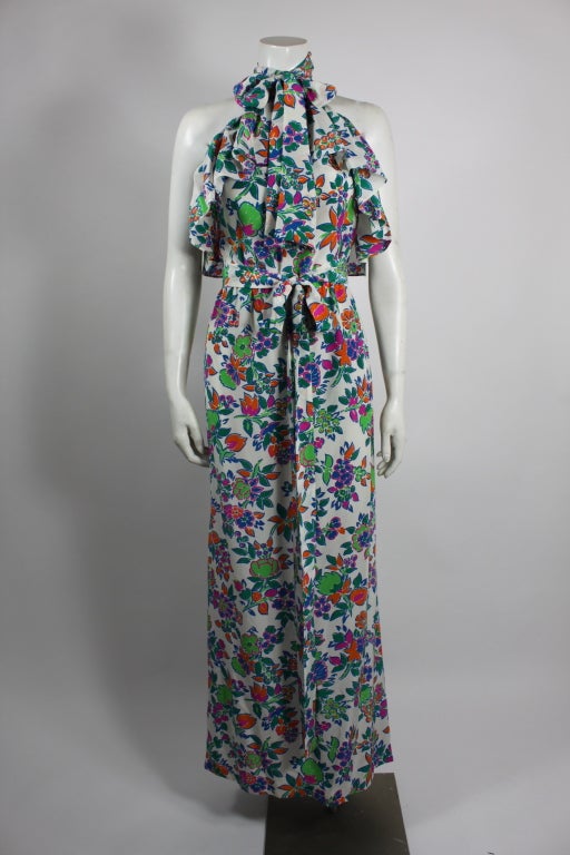 This gorgeous silk maxi dress from YSL is the perfect light-weight summer dress. Trimmed around the neck with a wispy ruffle and cinched at the waist with matching silk belt, this floral print is a stunner. 

Side zip. Unlined.
Excellent
