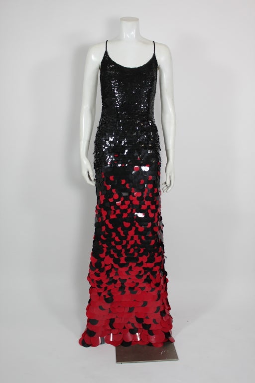 This show-stopping gown is covered in black and red layers of graduated paillettes, growing from smallest to largest from the top to the bottom. Stunning, textured, and unique, this gown is a fabulous example of whimsy and chic. 

Unlined.