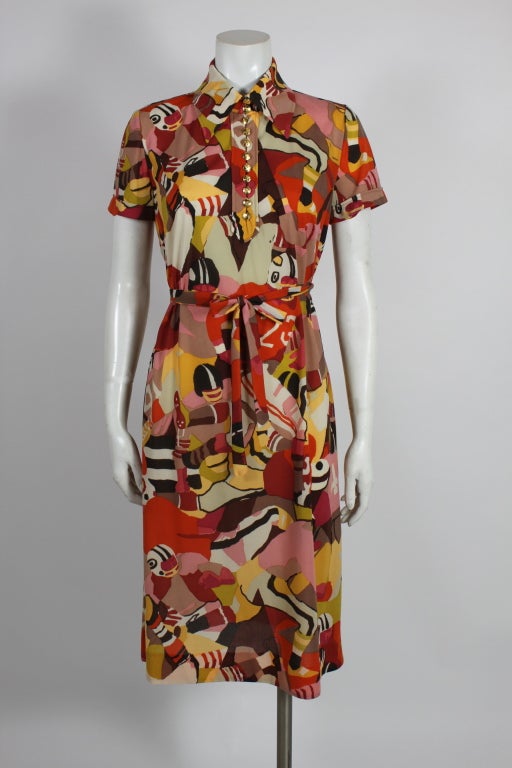 This fabulous collared dress from Ken Scott is done in a bold, graphic print of camouflage football players. Accented with gold signature Ken Scott buttons and a matching belt.

Unlined.