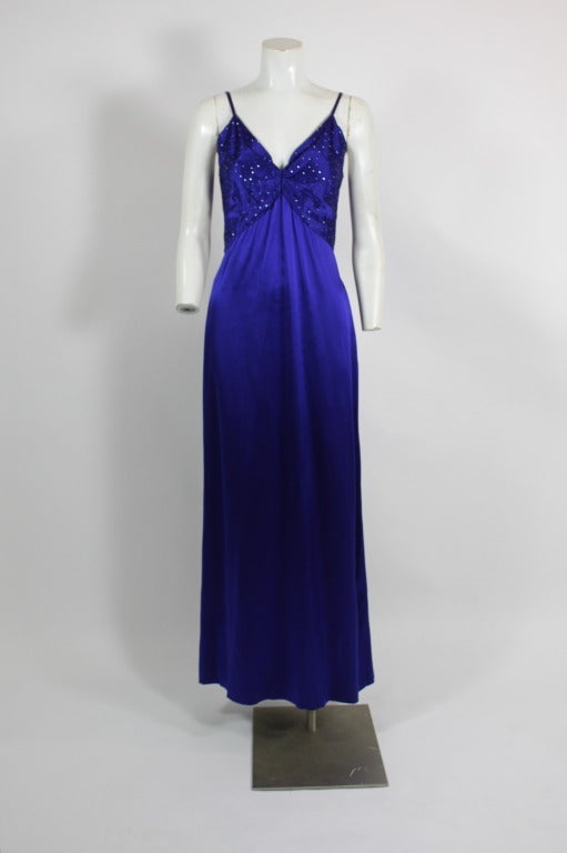 Fabulous electric blue silk/wool gown from Christian Dior Boutique. Bodice accented with complementary blue rhinestones. Gown has matching blue caftan cover accented with rhinestones.