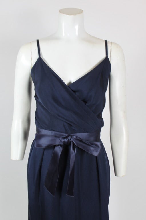 A silk wrap gown from Christian Dior couture, Printemps-Été 1984. Equal parts tailored and sexy, gown is accented by a feminine navy silk bow belt, and has accompanying tailored jacket. Jacket hooks in center.

Jacket-
Bust: 38 inches
Length: 20