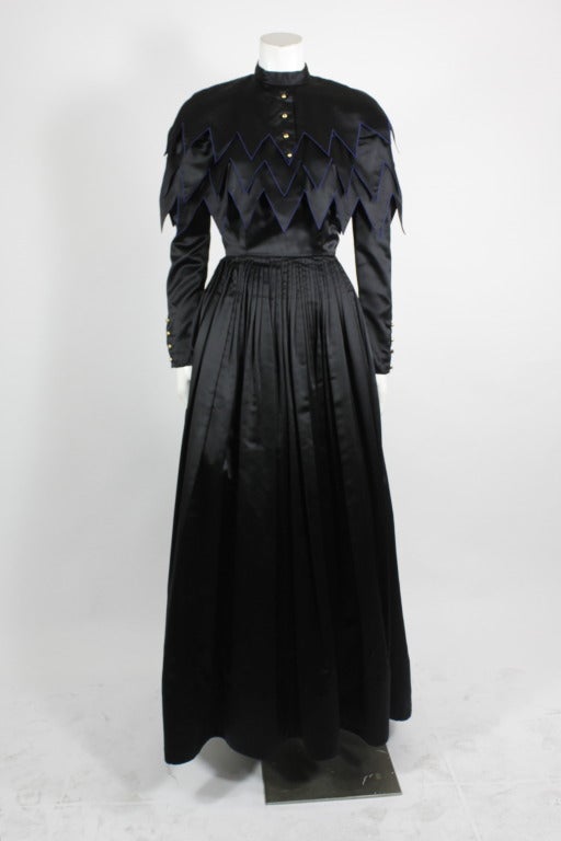 Chanel goes a bit goth with this fabulous black ball gown. Inspired by Edwardian silhouettes, this gown is given a modern, updated feel with the tiered geometric bodice. The high neck and long sleeves are offset by the whimsical design and detail.