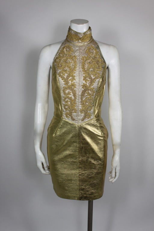 A fabulous gold leather halter dress from Michael Hoban’s North Beach Leather. The bodice of the dress is embellished with gold bullion embroidery throughout, in an almost Grecian motif. Dress is fully lined. Leather in excellent condition. Labeled