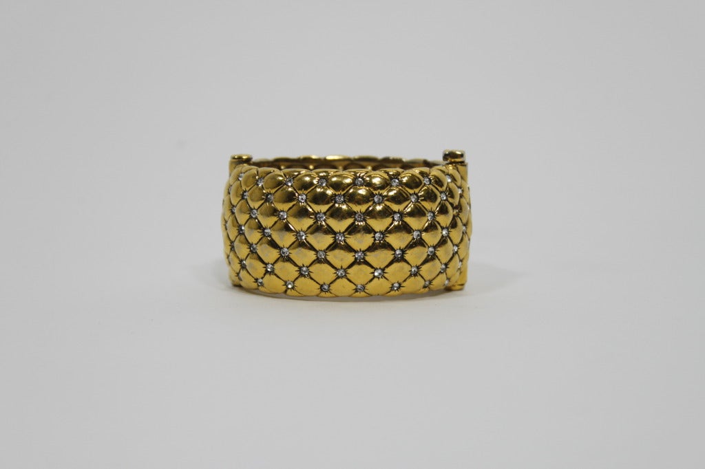 Fabulous goldtone quilted cuff from legendary couture costume jewelry house Goossens Paris, embellished with rhinestones throughout. Clamper cuff attaches secures with pin hinge. Please note, there is some wear throughout cuff (pictured). All