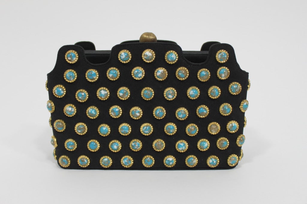 Lovely 1960s evening bag from Lewis, done in structured black with faux-turquoise and metallic flecked cabochons throughout. Purse has handles that can be tucked away. 

Measurements--
Length: 7.5 inches
Height: 4.25 inches
Width: 2.5 inches