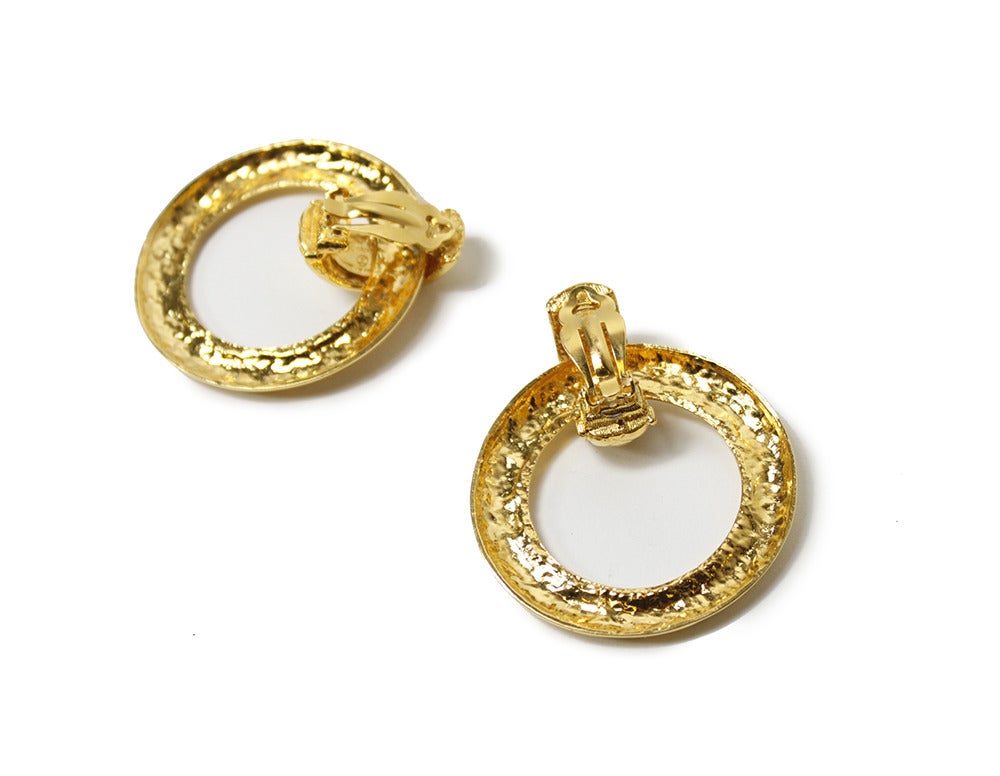 Fabulous gold plated hoop earrings from CHANEL. Done in the iconic CHANEL quilted pattern, the earrings can be worn with or without the hoop. 

Measurements--

Hoop: 1.75 inches 
Clip: 1 inch
Total Length with Hoop Attached: 2 1/8 inch