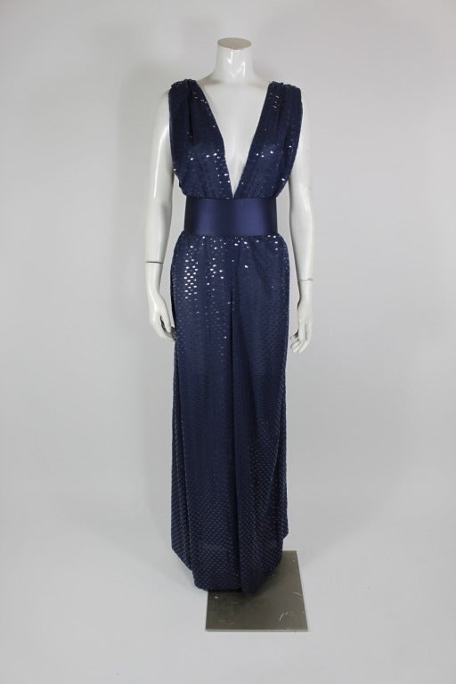 An incredible navy blue palazzo pant jumpsuit from Galanos, accented with metallic appliques throughout. 
-Unlined
-Gathered shoulders

Measurements--
Bust: up to 40 inches
Waist: up to 44 inches
Hip: up to 40 inches
Inseam: 33