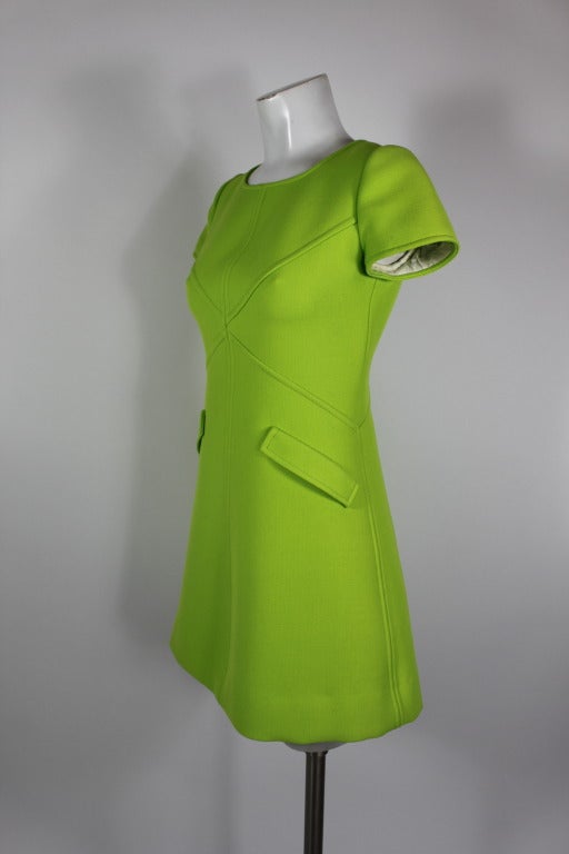 An absolutely fabulous and iconic wool mini dress from Courreges done in a striking electric green. Dress is A-line with faux pockets.

-Fully lines
-Zip back

Measurements--
Bust: 32-34 inches
Waist: up to 30 inches
Hip: up to 38