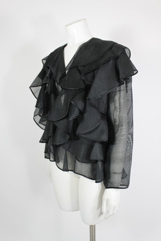 An avant-garde black ruffled jacket from Galanos. Done in tiers of gorgeous silk gazar ruffles throughout and finished with satin bias piping, the jacket is stunning.