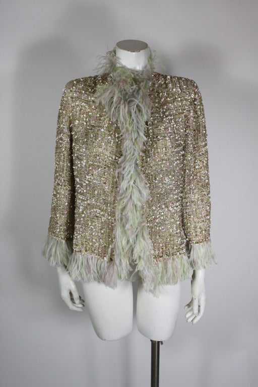 A spectacular evening jacket from Oscar De La Renta. The multicolored pastel jacket is fully covered in sequins and glass beads, a textured, dimensional take on traditional bouclé tweed. Trimmed in pastel ostrich feathers.

-Fully lined in silk