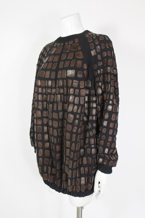 A stunning silk tunic from fashion architect Ralph Rucci. The tunic is adorned in alligator appliqués throughout. 

-Fully lined in silk
-Zips in back
-Elastic at wrist and hem

Measurements--
Bust: 42 inches (flat)
Waist: 44 inches