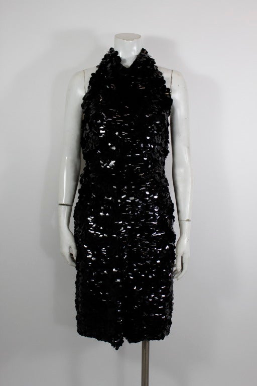 A sexy cocktail dress from American designer Donald Brooks. Covered in black paillettes, the halter dress is fitted throughout with a blouson waist.

-Fully lined
-Petersham
-Zips in back

Measurements--
Bust: 34 inches
Waist: 25