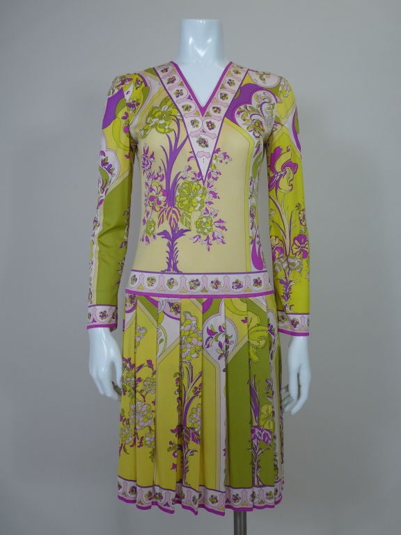 Lightweight silk jersey floral printed dress from Emilio Pucci in summery chartreuse, tan, pink and magenta. 1920's sportswear-style silhouette with drop waist, pleated skirt and v-neck. Zip-back.<br />
<br />
Measurements:<br />
Bust: 34