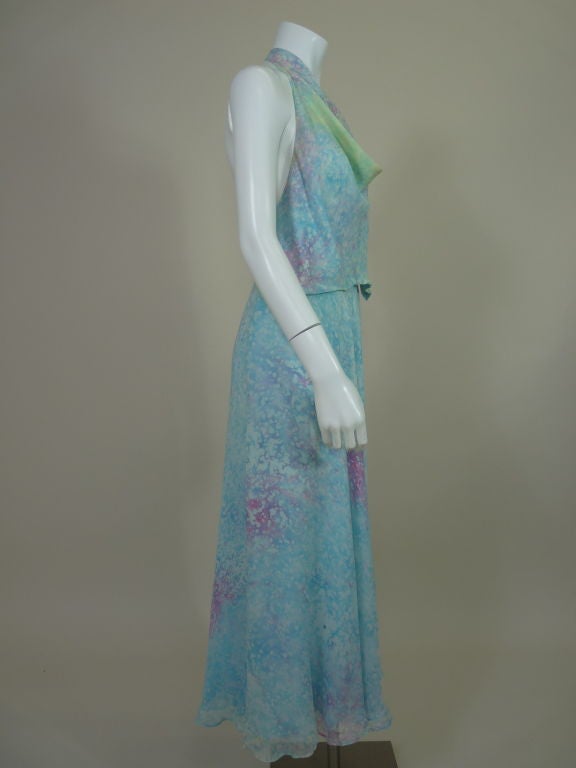 Diaphanous two-piece printed silk ensemble from Halston. Sky blue abstracted bubble print is reminiscent of an Impressionist painting of water highlighted with splashes of pink, violet and light green. Halter top has cowl neck and ties in the back