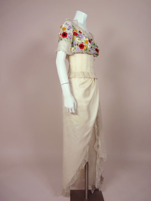 Couture white silk organza two piece ensemble from Christian Dior. Bodice is covered in exquisite Lesage embroidered flowers and butterflies done in silk ribbons of various weights and colors. Embroidery is embellished with iridescent mint green and