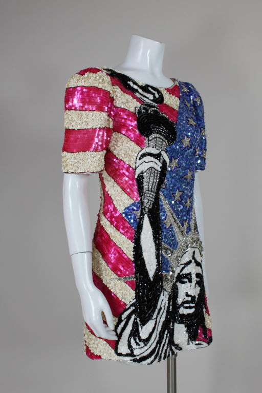 1980's hand-embroidered sequin patriotic themed mini dress from French designer, Aurelie Marciano. A graphic Statue of Liberty is embellished on the front of the dress with black, white and silver iridescent sequins, round silver beads, large sew-on