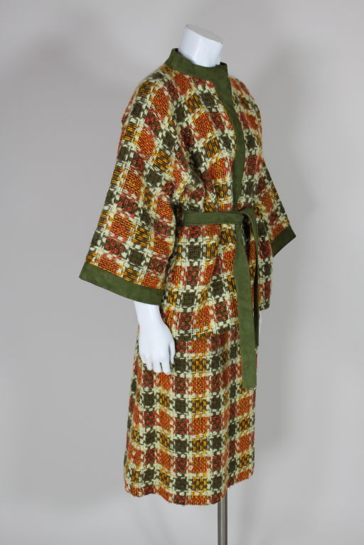 Bonnie Cashin autumnal colored tweed two piece ensemble features an olive suede belted jacket and pencil skirt. Jacket has wide, 3/4 length kimono sleeve, side slash pockets and hits at mid-hip. Ensemble is done in a textured tweed check in shades