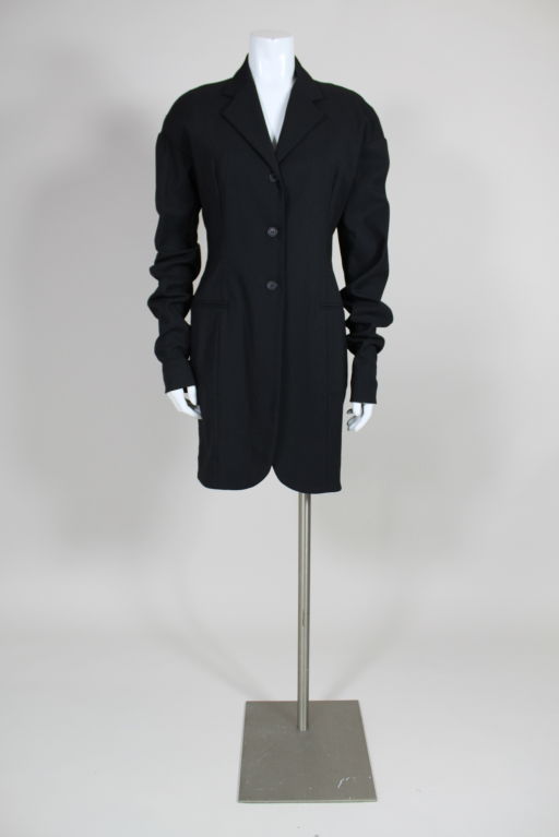 Black wool blend single breasted jacket from Dolce & Gabbana has extra long sleeves that are worn scrunched and cinched at the wrist with button and loop closure. Sleeves are dropped and shoulders are rounded.<br />
<br />
Measurements--<br