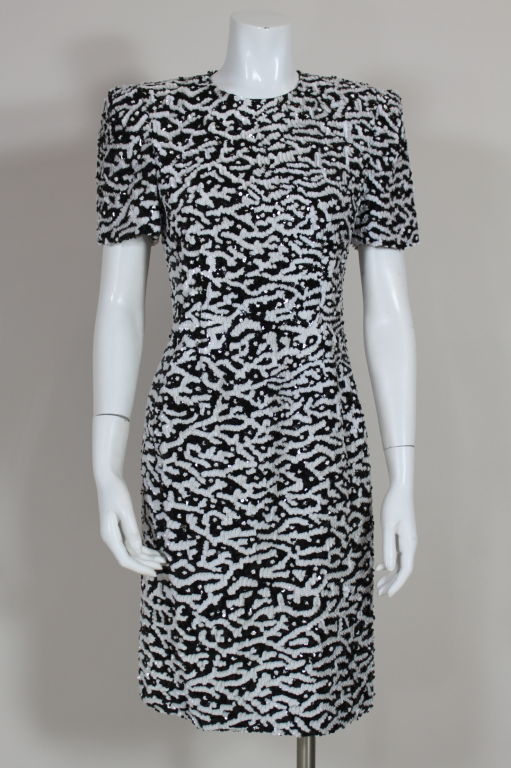 Carolina Herrera cocktail dress is fully encrusted with opaque black and white sequins and glass beads in an organic, mottled pattern. Shoulders are padded for a structured, tailored silhouette. Fully lined, back zip. <br />
<br