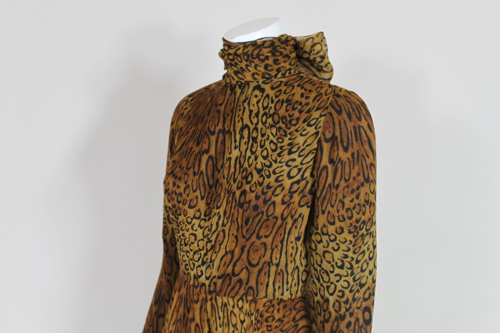 Long-sleeved, wide legged, leopard print chiffon jumpsuit has attached peplum skirt and dramatic wrap around neck scarf that can be tied into a bow or left to drape over the shoulders. Fully lined. Zip back.<br />
<br />
Measurements--<br