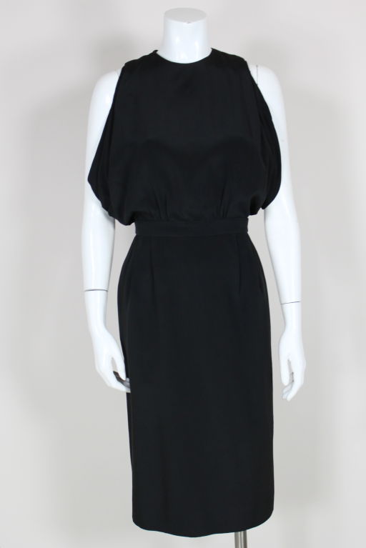 Fabulous black silk crepe cocktail dress from iconic designer Don Loper features a sleeveless bodice that is pleated from the shoulder and releases into three layers of draped tiers under the arms to create a blouson effect. Peek-a-boo back is