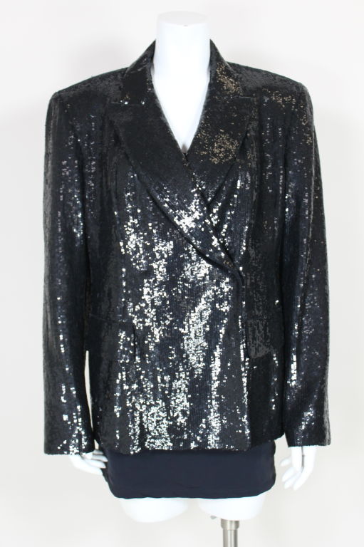 Sleek, fully sequined, tuxedo-style jacket from Donna Karan features two decorative pocket flaps in front, notched collar and padded shoulders. Fully lined, hidden snap closures.<br />
<br />
Measurements-<br />
Bust: 42