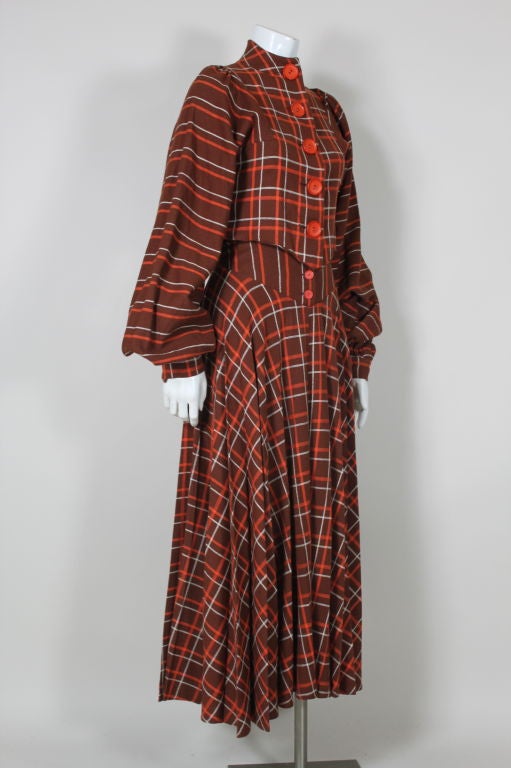 Early 1970's Miss Mouse checked wool twill ensemble features a button front blouse with a high, collarless neckline, and voluminous, raglan style sleeves that are gathered from the shoulder and wrist. Full skirt is pleated from the waist yoke.