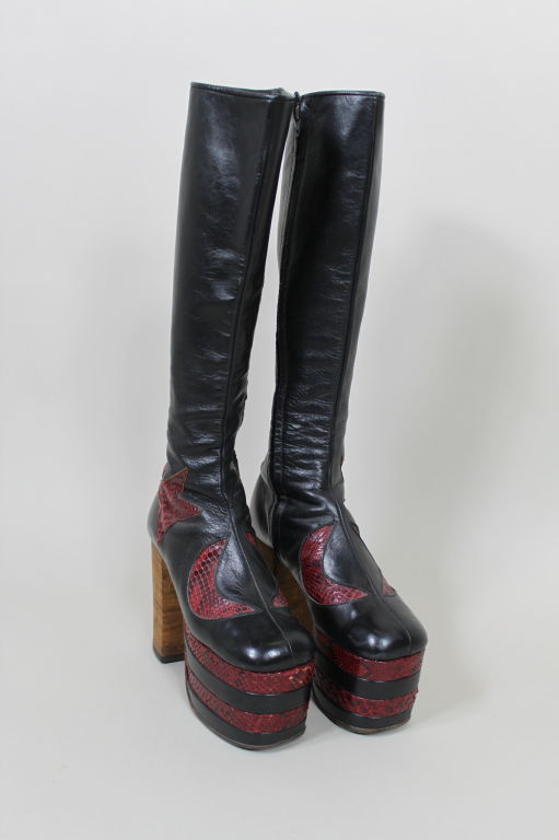 Amazing platform 1970s glam rock leather boots are said to have been originally hand made for legendary rocker David Bowie. Boots have stacked wood heels with alternating leather and snakeskin platforms. Appliqued snakeskin moons and stars decorate