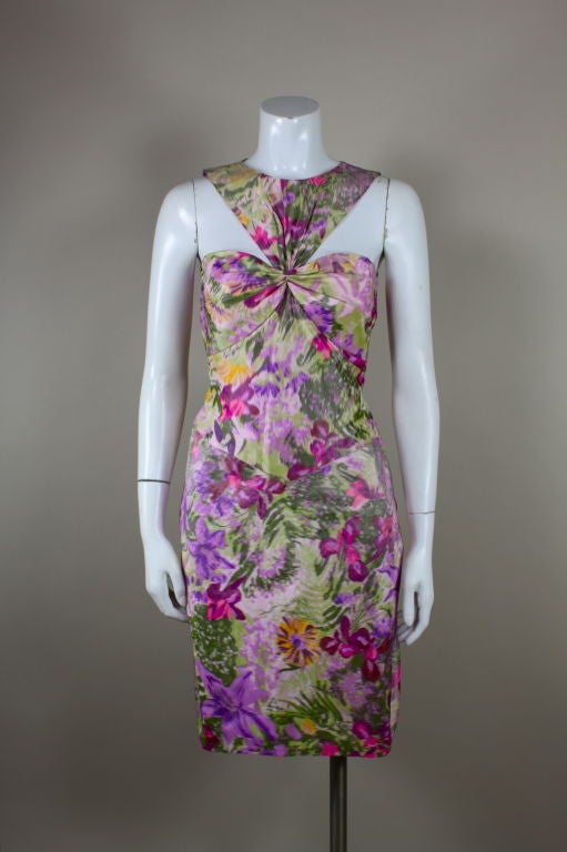 The most perfect dress for a spring cocktail party, this Bill Blass confection is made from a watercolor floral chiné silk taffeta done in a delicious palette of violet, fuschia, grass green and golden yellow. An architectural silhouette contrasts