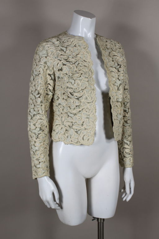 Gorgeous 1965 couture evening jacket from Christian Dior is made from the most beautiful heavily textured ivory cotton lace embellished with a soutache floral pattern. Lace is laid over layers of tulle and organza. Jacket is made in true couture