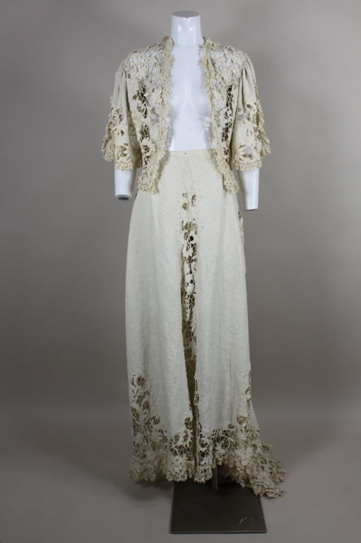 Fantastic Edwardian walking suit includes an ecru linen jacket with delicate cotton Battenburg lace. Linen is embroidered all over with monochromatic dots. Gathered sleeves are vented and trimmed with finely woven floral lace. Skirt is inset with