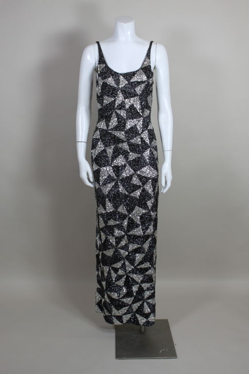 Ultra sexy knit gown worn by iconic soul singer Gladys Knight is embroidered all over with black and silver iridescent sequins in a kaleidoscopic geometric pattern. Low scoop back and high slit sides enhance the body conscious silhouette. <br