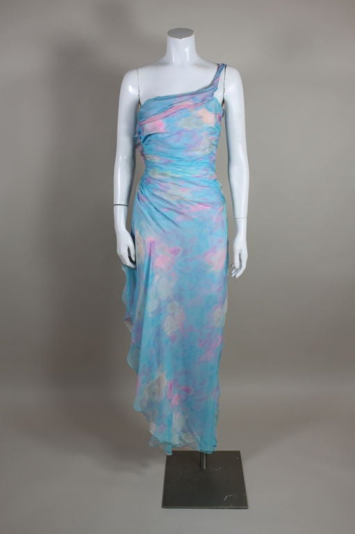 Ethereal party dress from Emanuel Ungaro is made from layers of pastel, watercolor floral silk chiffon in shades of sky blue, lavender and pink that are gathered into soft, radiating pleats for an asymmetrical silhouette. Lined in pastel pink
