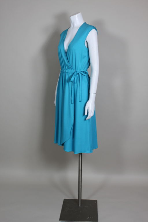 Adorable, bright aqua blue jersey wrap dress from iconic designer Stephen Burrows features cutouts along the back yolk. Edges are finished with Burrow's signature zig zag stitching. Lightweight jersey makes for the perfect summer