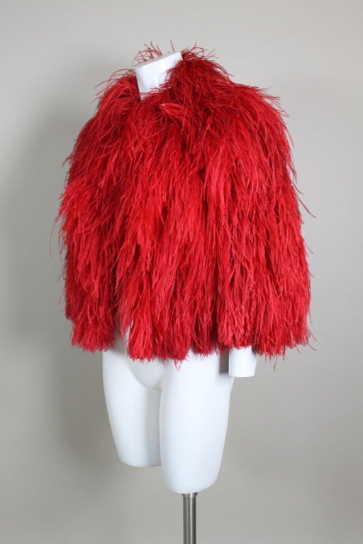 Fabulous 1970’s lipstick red ostrich feather capelet features layers of hand-sewn plumes. The hem's border has 18 plumes that act as a type of 