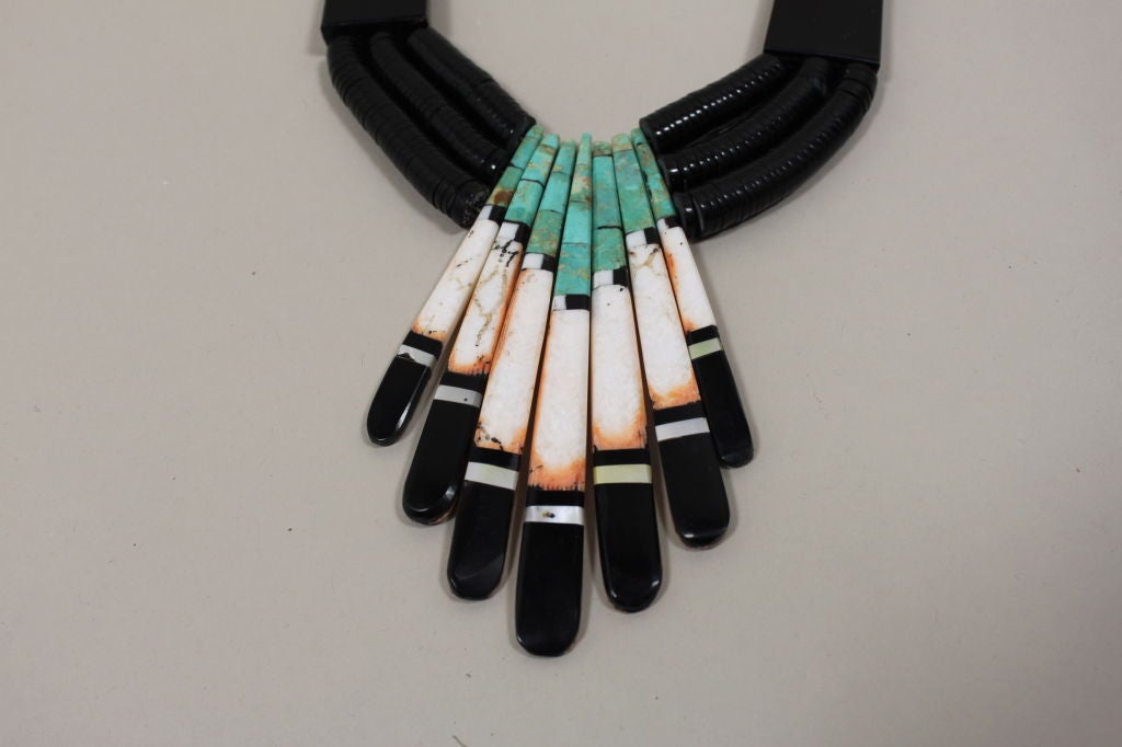 Gorgeous multi-strand necklace accented with inlaid stones and shells from the Santa Domingo pueblo in New Mexico.  The necklace consists of a double row of graduated shell heshi that has 2 long inlaid spacers in a horizontal inlaid pattern.  The
