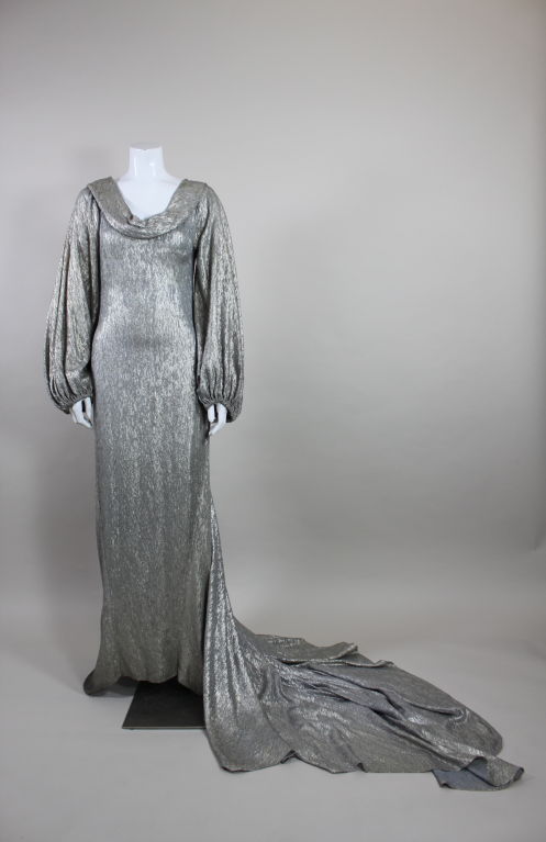Stunning 1930's bias cut silver lamé gown in classic princess style with long train.  Layered cowl neck with full gathered sleeves. The gown is cut so that there is a defined waist and is extremely flatterig.  It is even more beautiful in person and