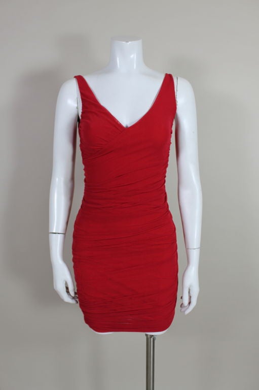Ultra sexy, body conscious cocktail dress from di Sant'Angelo is done in siren red stretch tulle, lined with matte jersey. Sleeveless dress has a criss-cross bodice with slinky ruching all the way down.  Keep in mind because of the stretch, sizing