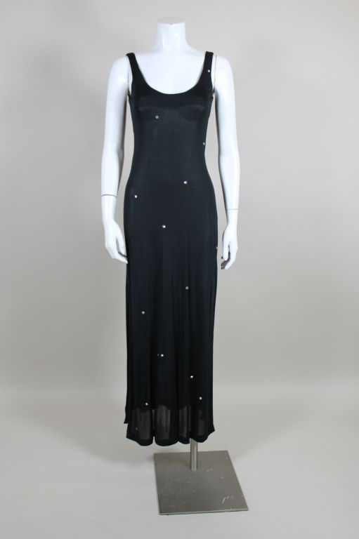 Fantastic, slinky silk jersey tank dress from Halston is decked with hand sewn Swarovski crystal accents. Lightweight jersey dress hugs the body with a low scoop neck and a slit up the side.