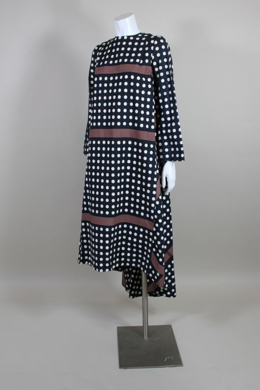Gorgeously graphic cotton dress from Finnish design house Marimekko is printed with bold white polka dots and brown stripes on a black ground. The play of shapes on this silhouette is fantastic! Dress is cut in a trapeze style, with a bias drape