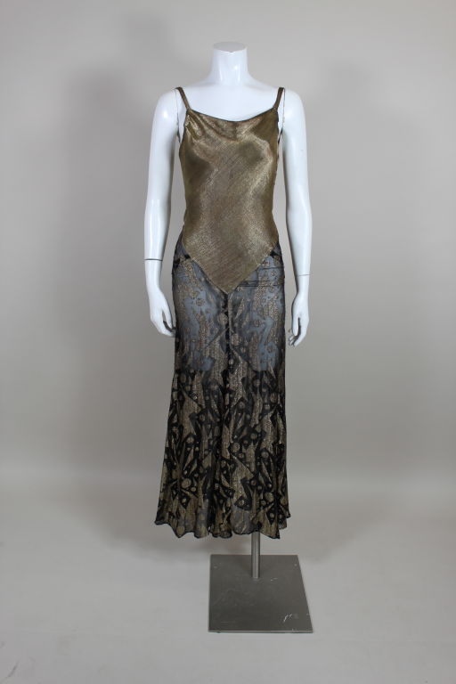 Stunning, slinky 1930's gown has a metallic gold lamé bias cut bodice and a flowing chiffon/lamé brocade skirt woven with gold geometric motifs inspired by the Russian Suprematist movement of the early twentieth century. Gown fastens at the side