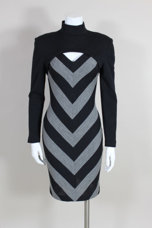 Sexy, body conscious sweater dress from Patrick Kelly is knit with a graphic black and heather gray chevron pattern. Turtleneck top panel reveals a peekaboo cleavage. Measurements below are at maximum stretch. Fits several sizes.

