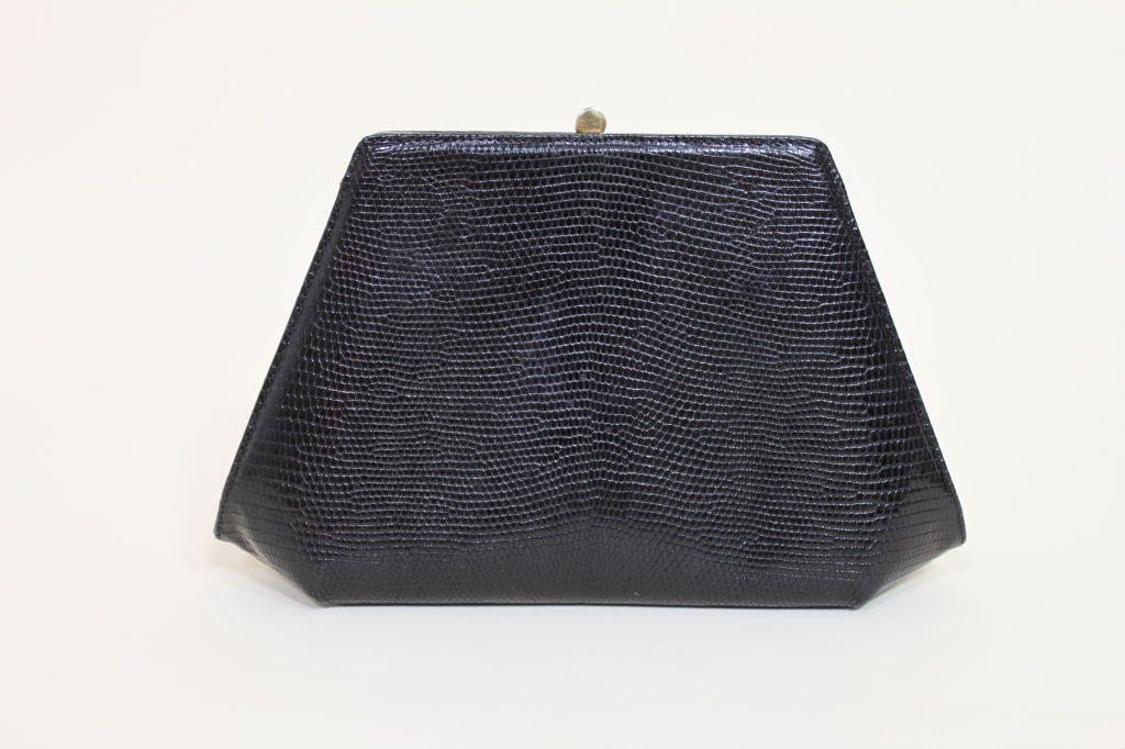 Luxurious reptile skin clutch from Bottega Veneta is done in a structured geometric silhouette with a gold clasp. <br />
<br />
Measurements-<br />
<br />
Height: 6