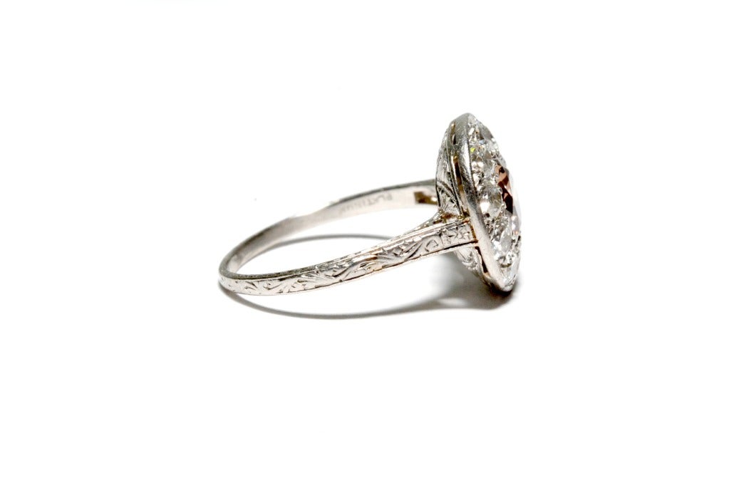 Circa: 1920's Art Deco

Metal:  Platinum

Style:  Diamond Ring  

Diamond : Center Champagne Old European Cut

Diamond Weight:  1.25ct.

Total Weight: 1.90ct

Hallmarked: Platinum